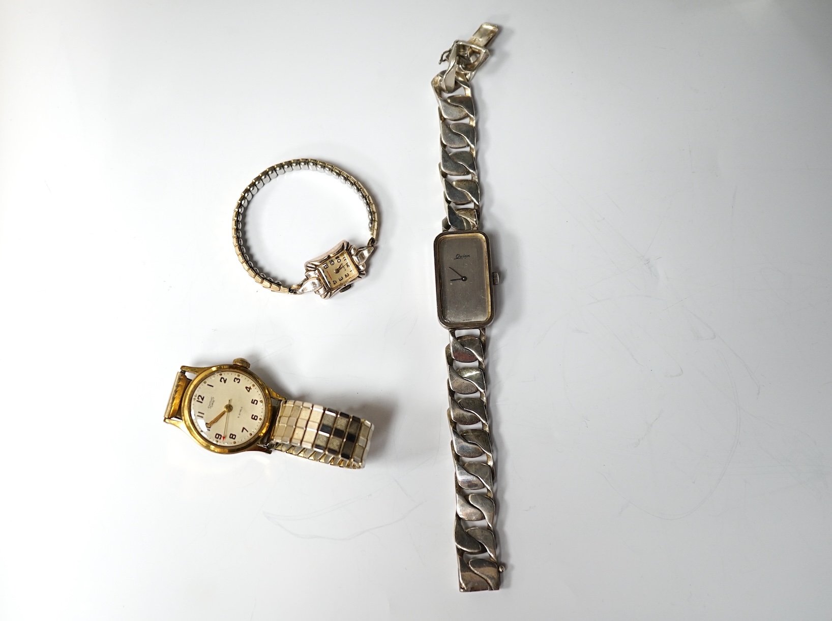 A lady's modern 925 Quinn wrist watch, with heavy silver curb link bracelet and two other wrist watches including a Smiths Empire. Condition - poor to fair